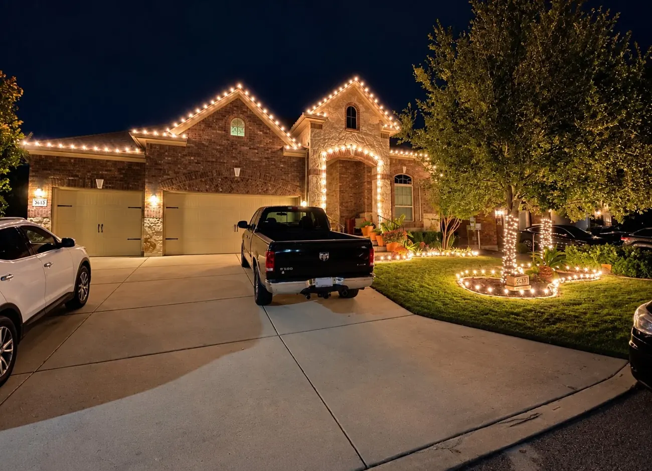 Brick home outlined in warm Christmas lights